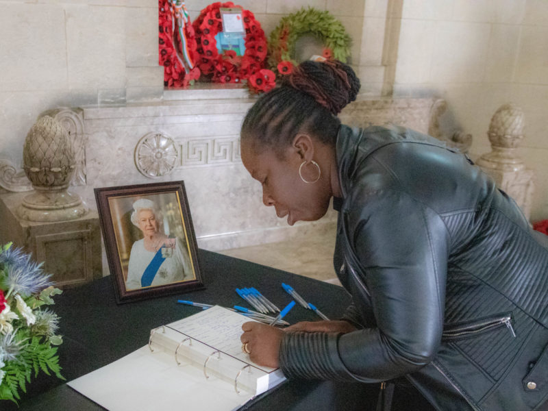 Paulette signs the book of condolence.